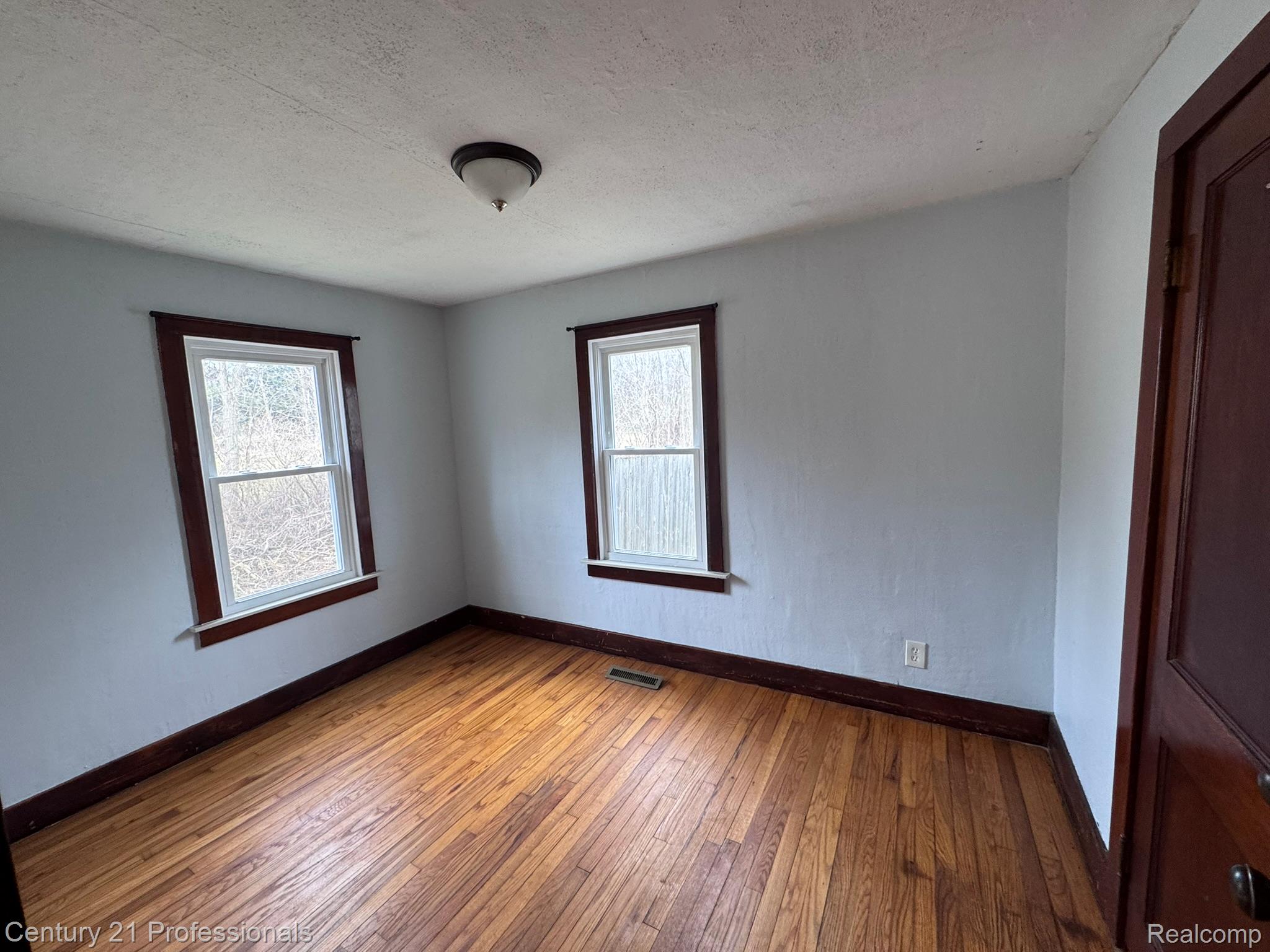 2021 West Rose Center Road Holly, MI 48442 - Photo 25 of 30 Empty room with dark wood-style floors and a textured ceiling