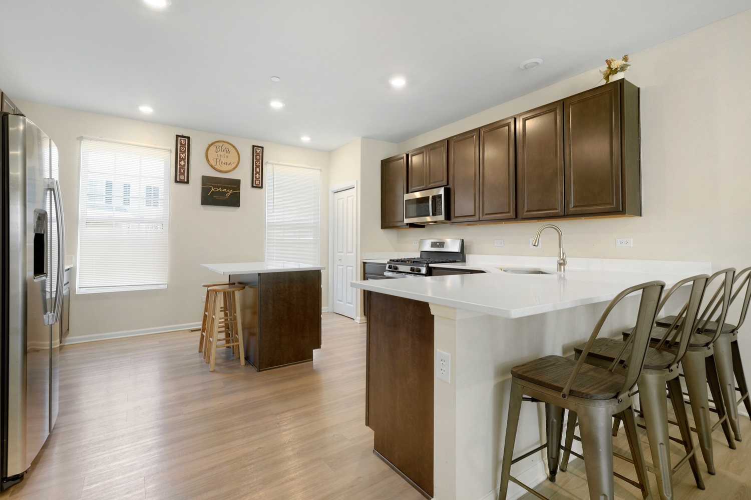 10306 Kerry Ridge Court Chicago Ridge, IL 60415 - Photo 11 of 26 a kitchen with stainless steel appliances kitchen island granite countertop a stove a sink a refrigerator and a microwave
