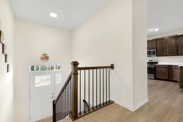 a view of a hallway with kitchen and entryway