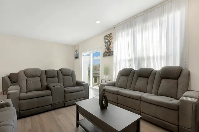 a living room with furniture and a large window