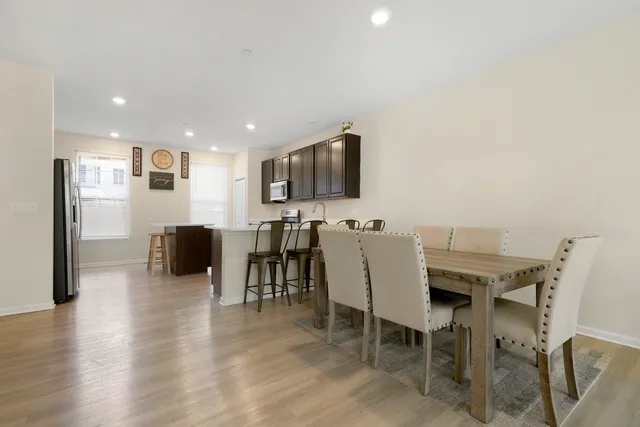 a view of a dining room with furniture and a flat screen tv