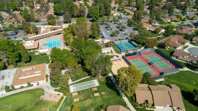 an aerial view of a house with a yard and lake view