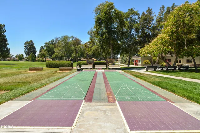 a view of backyard with swimming pool and green space