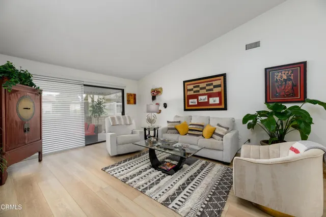 a living room with furniture and a potted plant