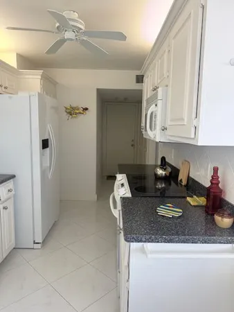 a kitchen with a refrigerator a stove and cabinets
