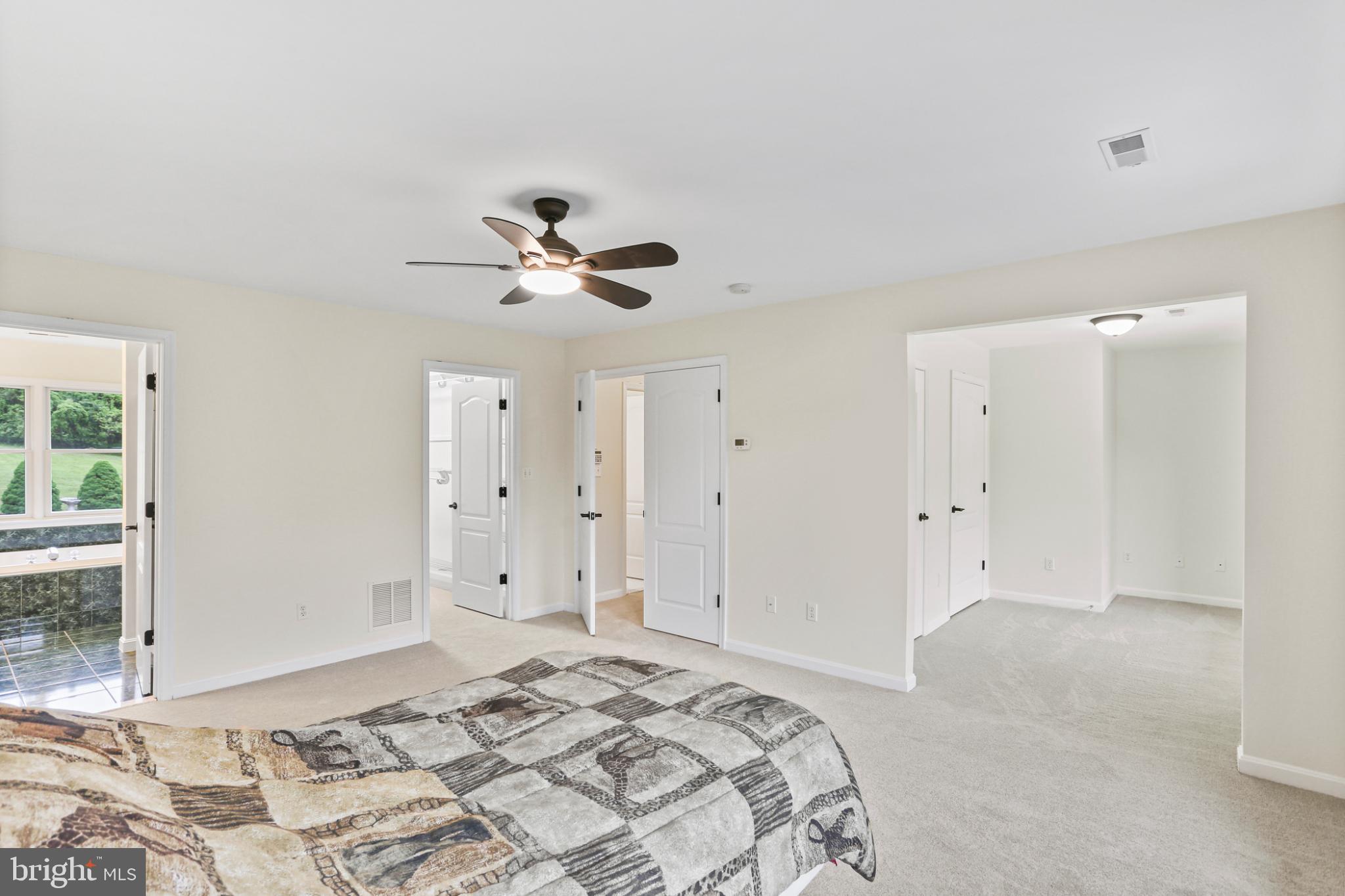 3547 Green Spring Road Havre de Grace, MD 21078 - Photo 15 of 50 a bedroom with a large bed and a chandelier fan