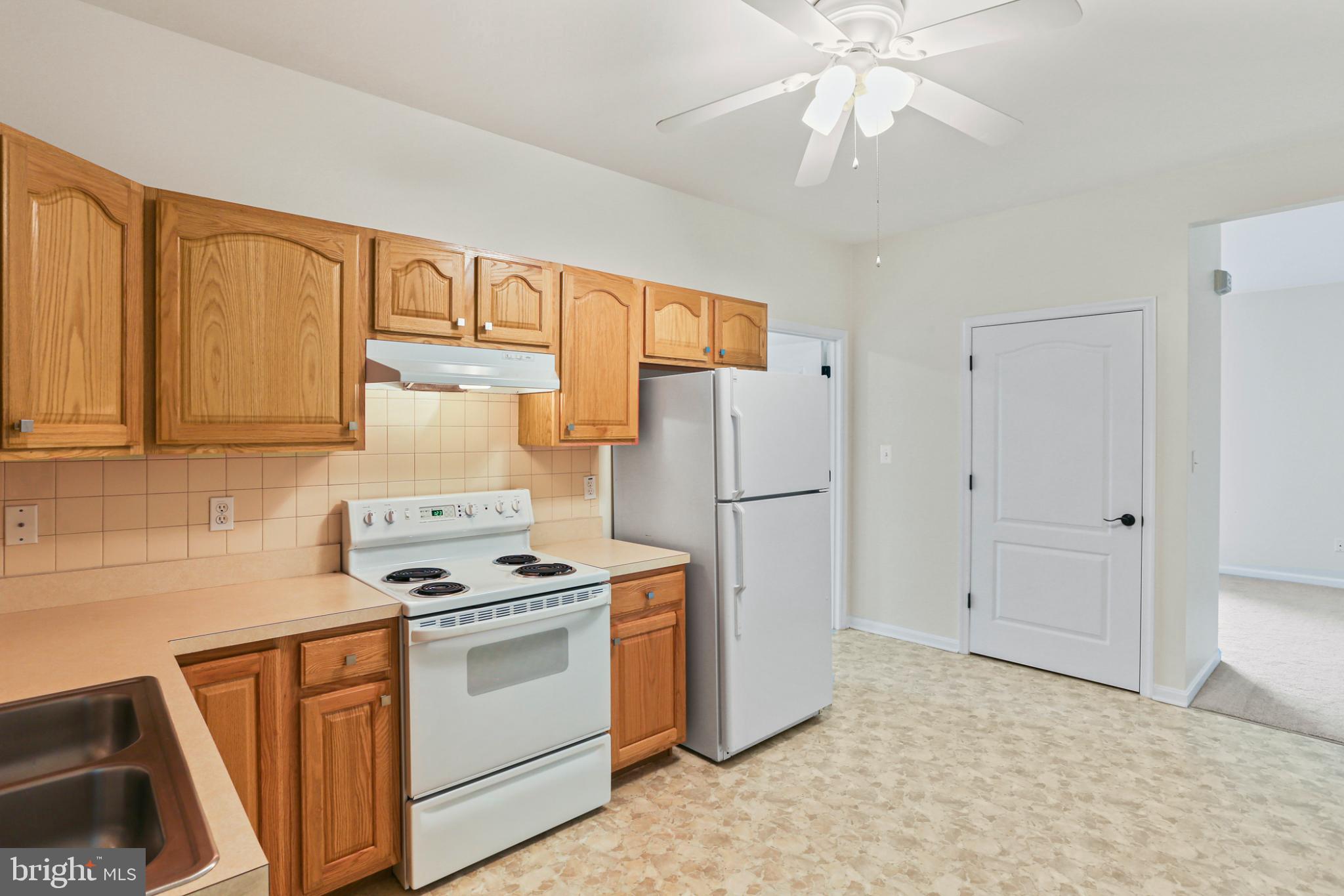 3547 Green Spring Road Havre de Grace, MD 21078 - Photo 30 of 50 a kitchen with stainless steel appliances a refrigerator a stove a sink and cabinets