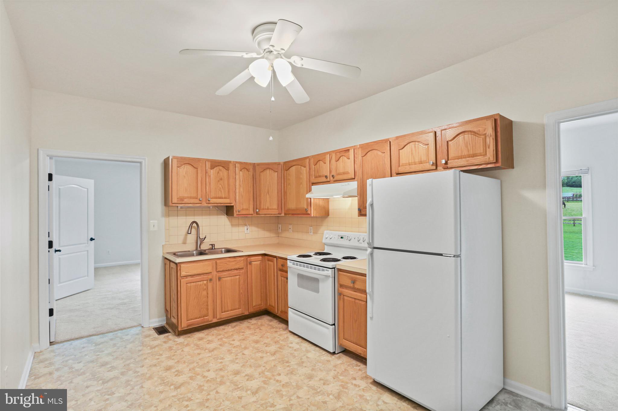 3547 Green Spring Road Havre de Grace, MD 21078 - Photo 31 of 50 a kitchen with a sink a refrigerator and white cabinets