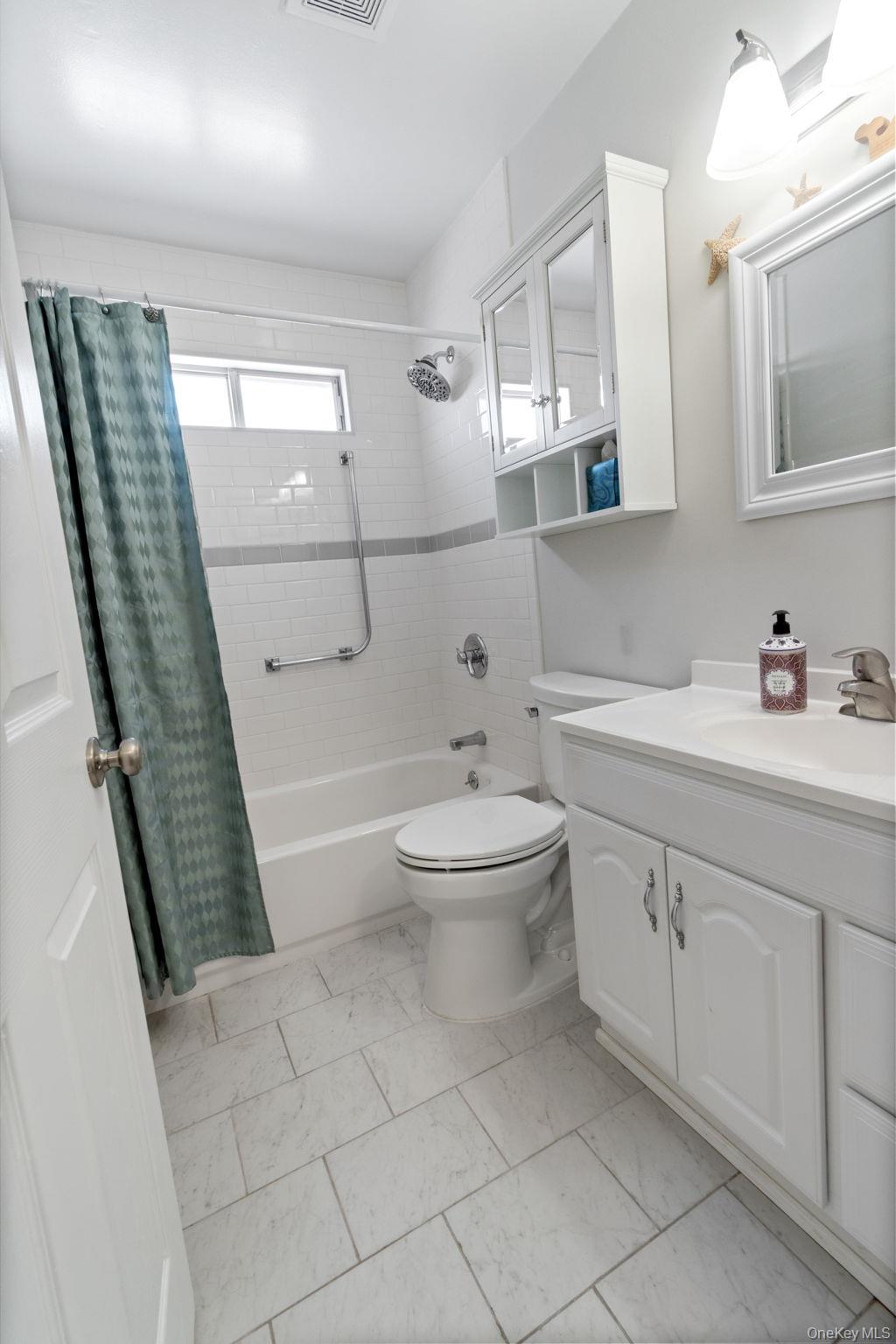 475 Stratford Lane Ridge, NY 11961 - Photo 13 of 16 a bathroom with a sink a toilet and shower