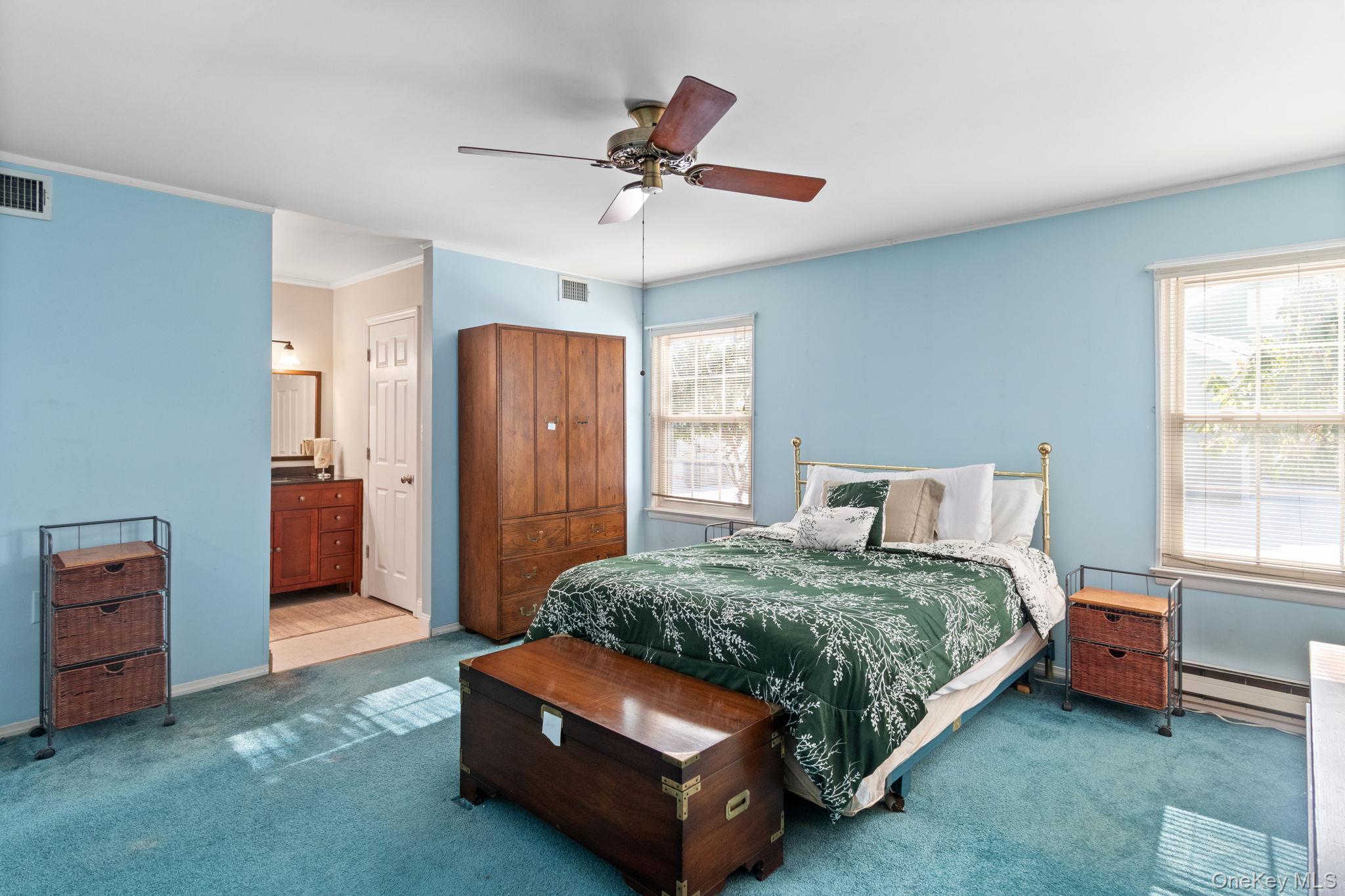 475 Stratford Lane Ridge, NY 11961 - Photo 15 of 16 a bedroom with a bed and a chandelier