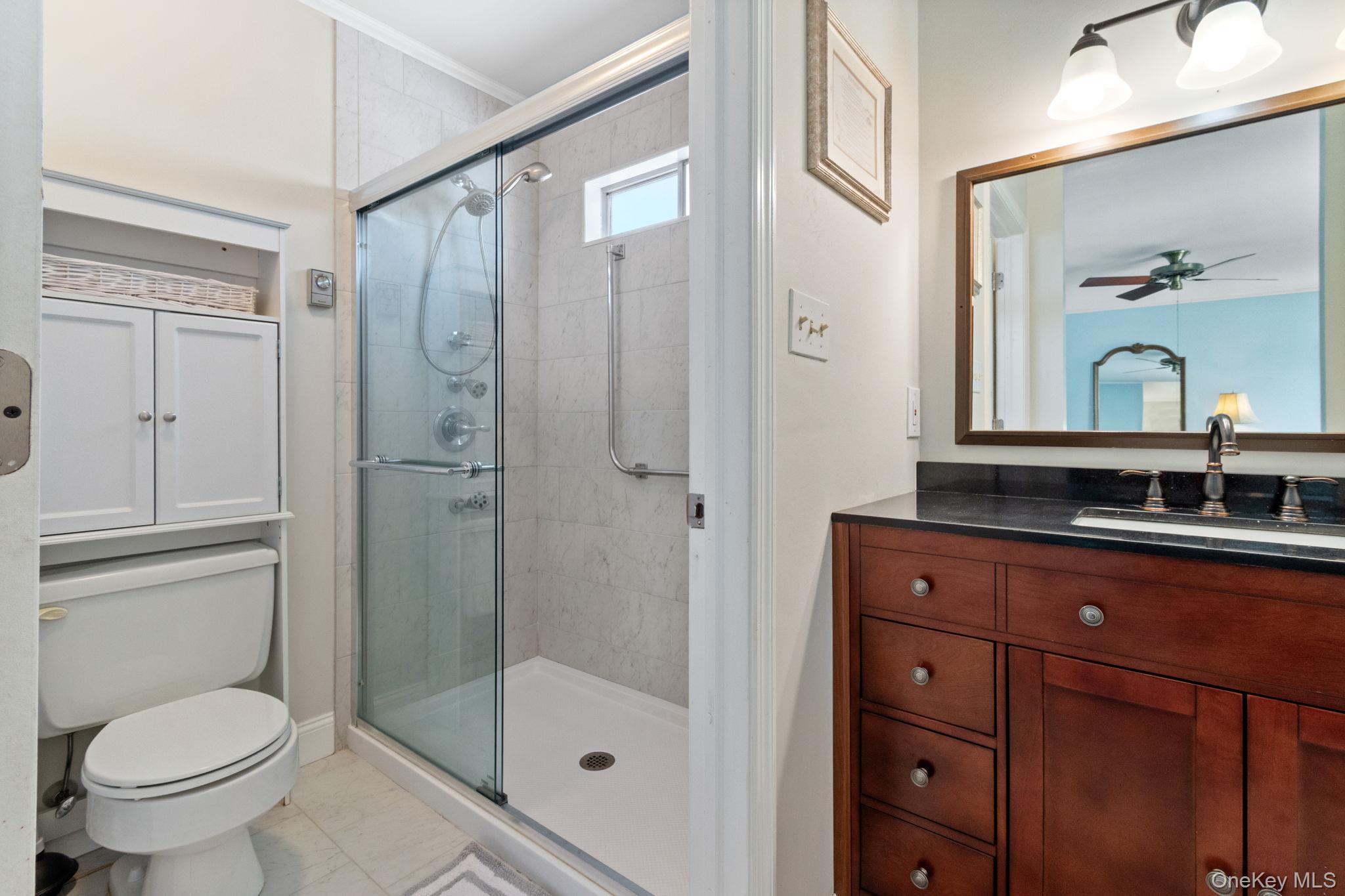 475 Stratford Lane Ridge, NY 11961 - Photo 16 of 16 a bathroom with a sink a toilet and shower