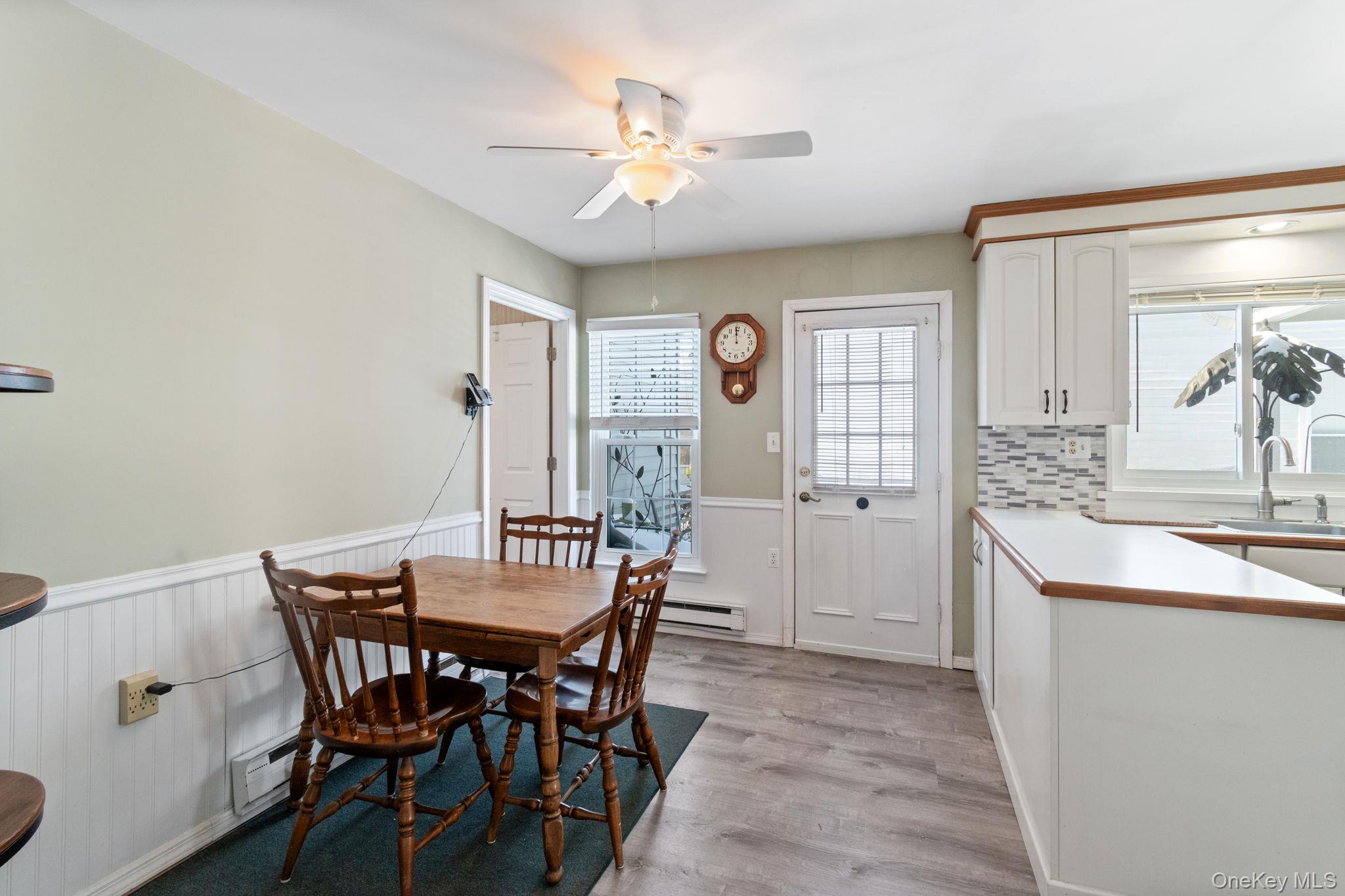 475 Stratford Lane Ridge, NY 11961 - Photo 8 of 16 a view of a dining room with furniture and a chandelier
