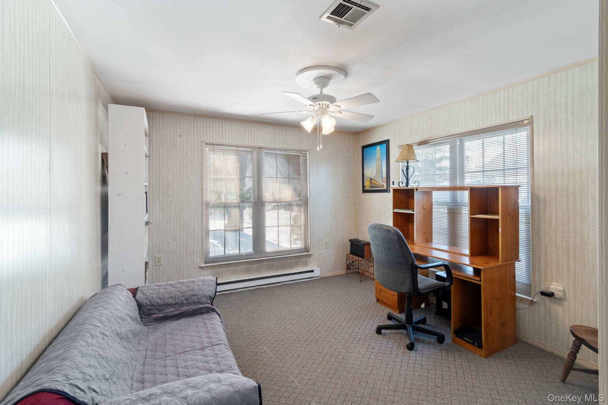475 Stratford Lane Ridge, NY 11961 - Photo 9 of 16 a bedroom with furniture and a window