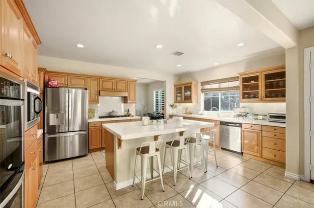 a large kitchen with a table and chairs