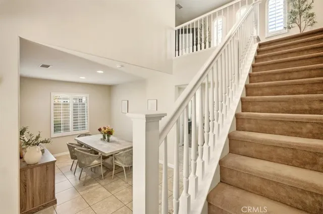 a view of a hallway with wooden floor and windows
