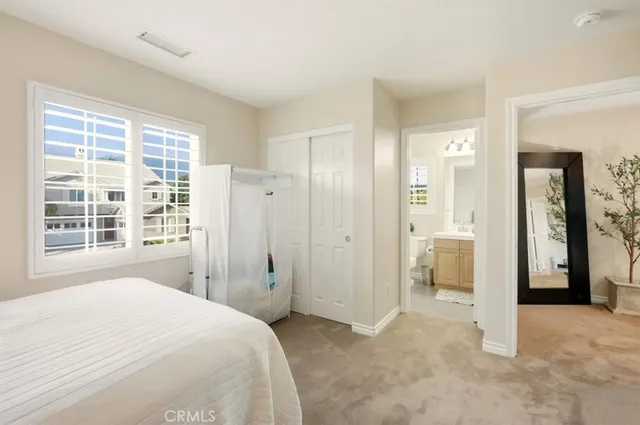 a bathroom with a sink a toilet a mirror and vanity