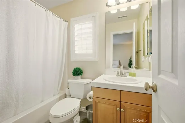 a spacious bedroom with a bed and a cabinets