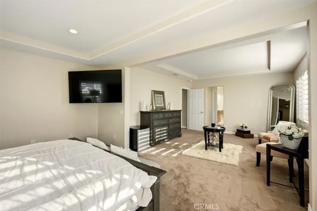 a large white kitchen with a sink and dishwasher a refrigerator with white cabinets