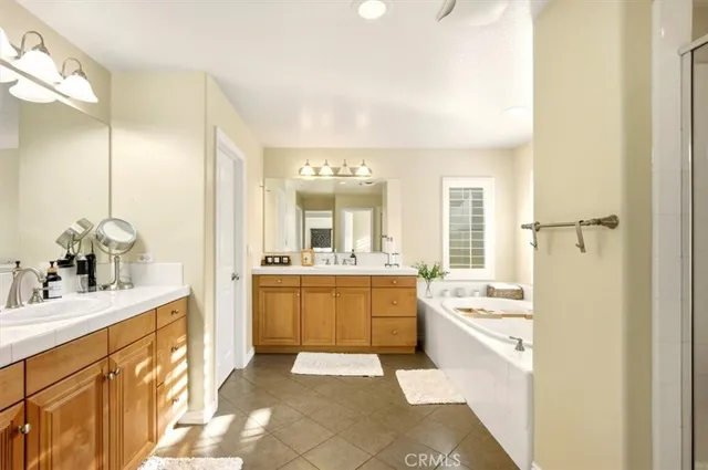 a large bathroom with a sink mirror and a bathtub