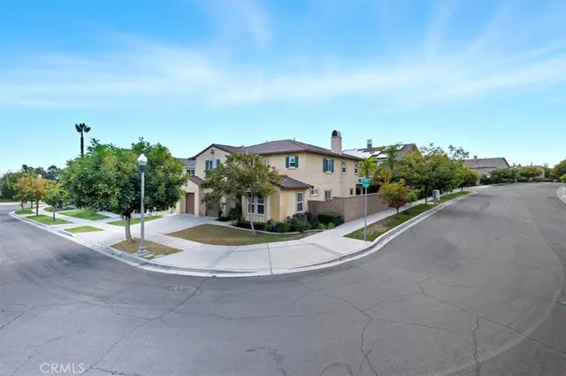 a front view of a house with a yard and road