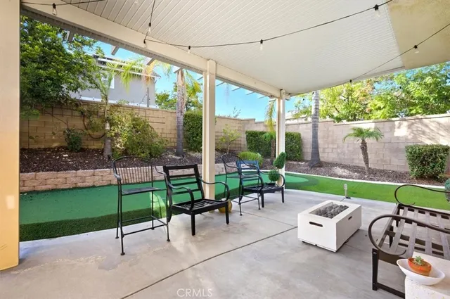 a view of a patio with a table chairs and a backyard