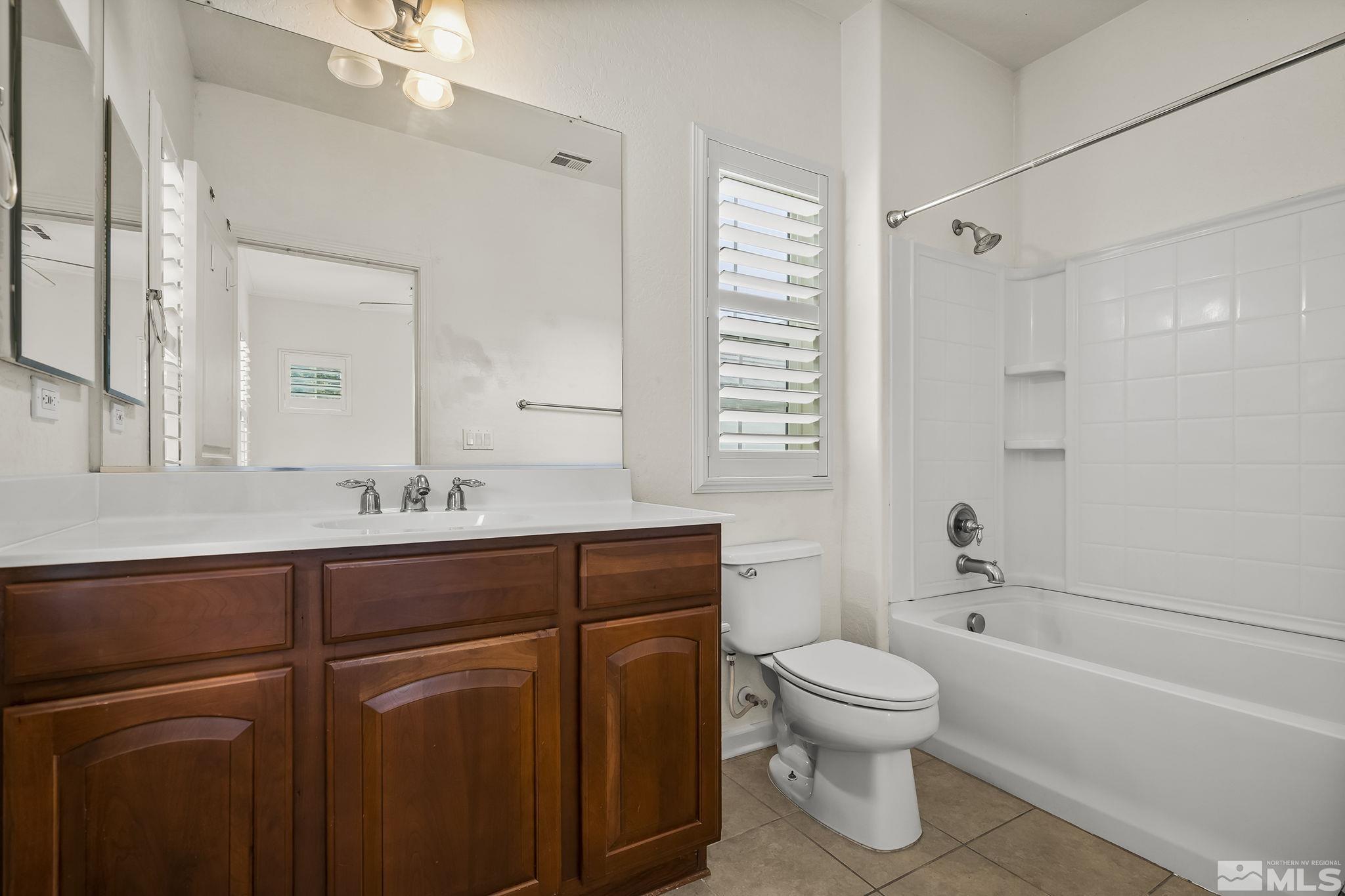 1355 Tarleton Way Reno, NV 89523 - Photo 20 of 40 a bathroom with a toilet sink and mirror