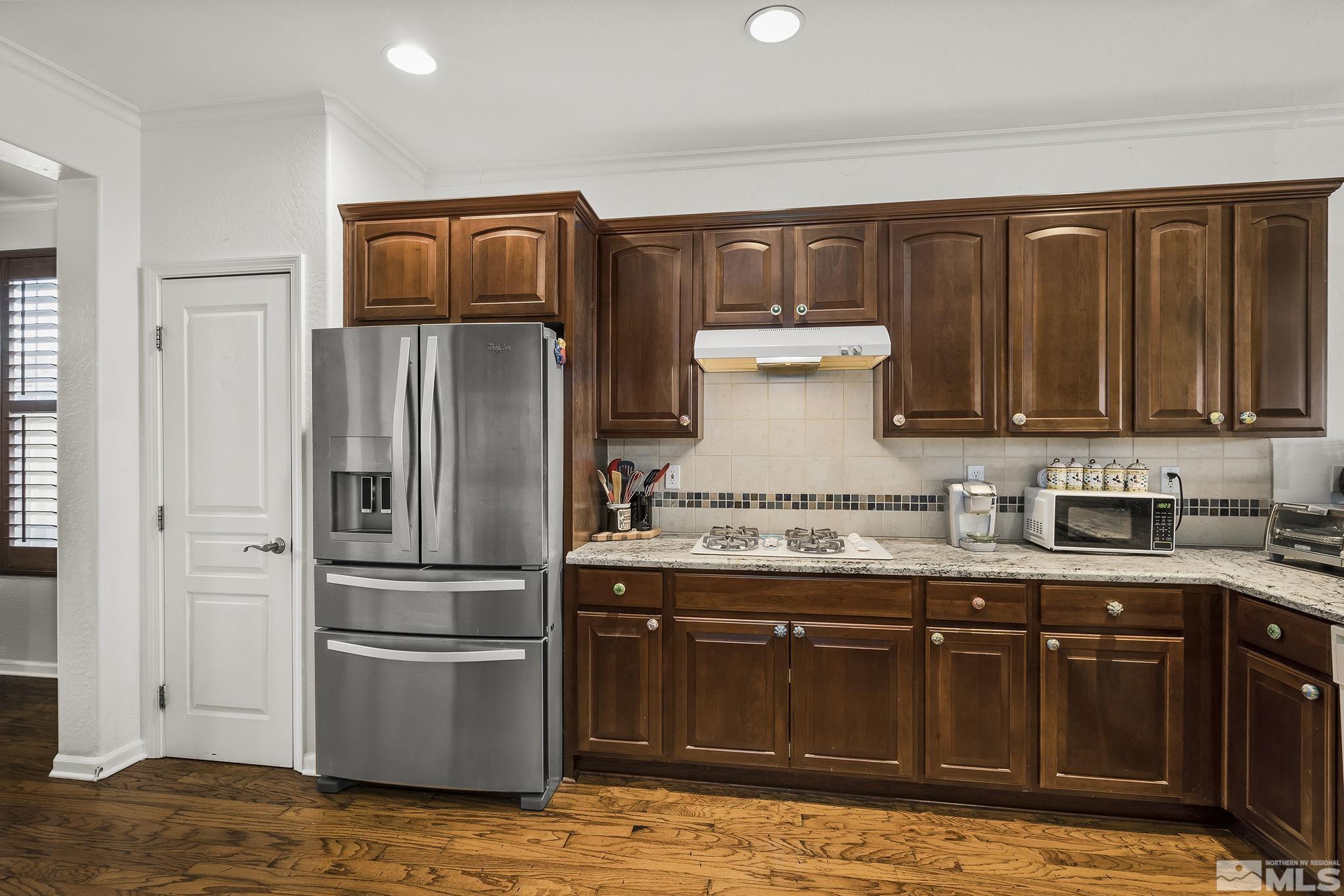 1355 Tarleton Way Reno, NV 89523 - Photo 9 of 40 a kitchen with stainless steel appliances granite countertop a refrigerator and a stove top oven