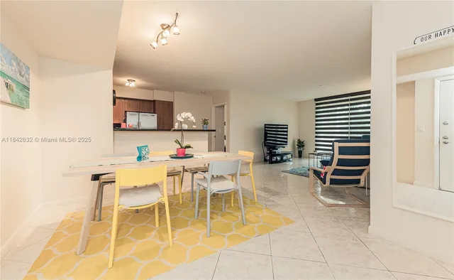 a dining room with furniture and a window