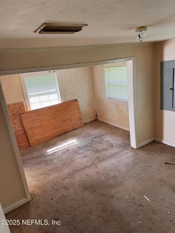 a view of an empty room with windows