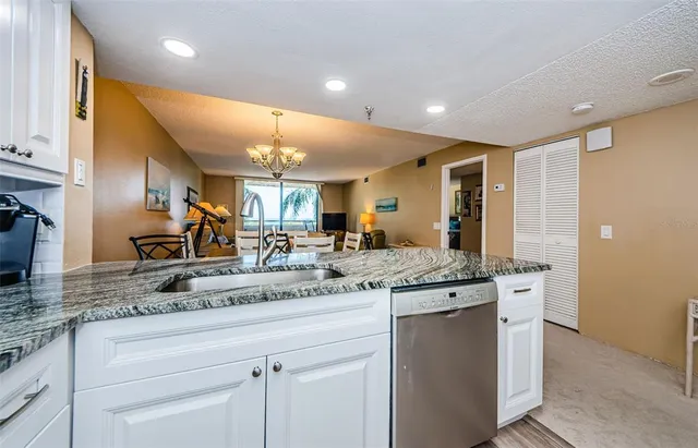 a spacious bedroom with a bed and a flat screen tv