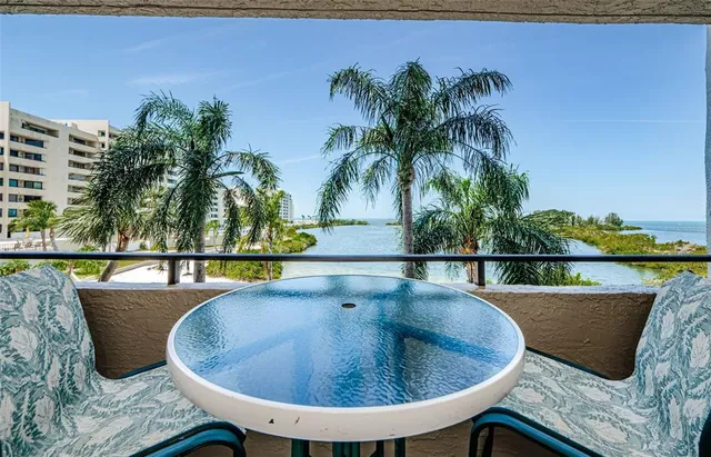 a living room with furniture a flat screen tv and a large window