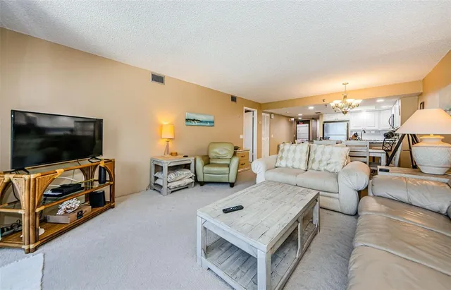 a view of a dining room with furniture and a chandelier