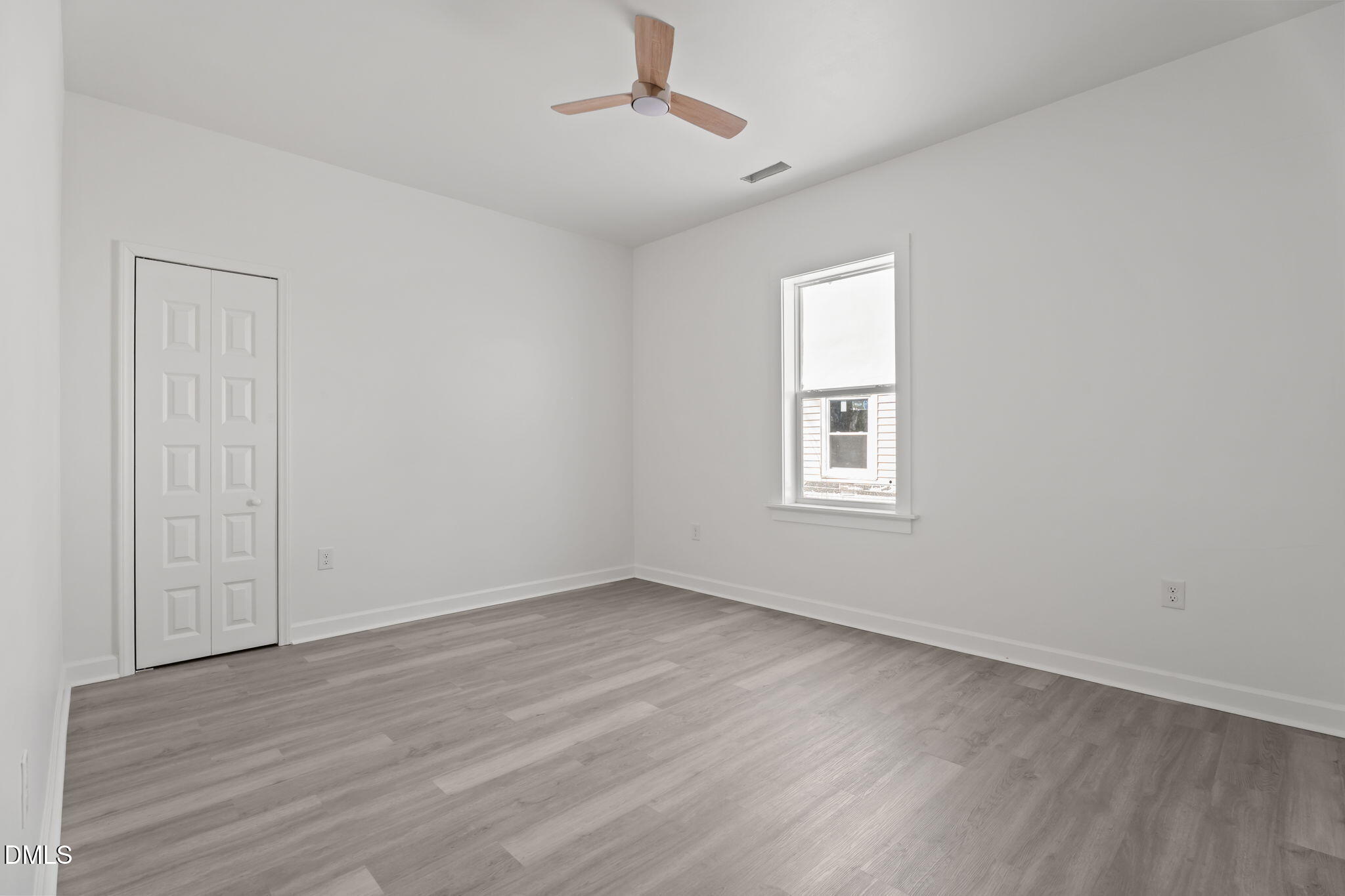 910 Gay Street Rocky Mount, NC 27804 - Photo 11 of 18 a view of an empty room with wooden floor and a window