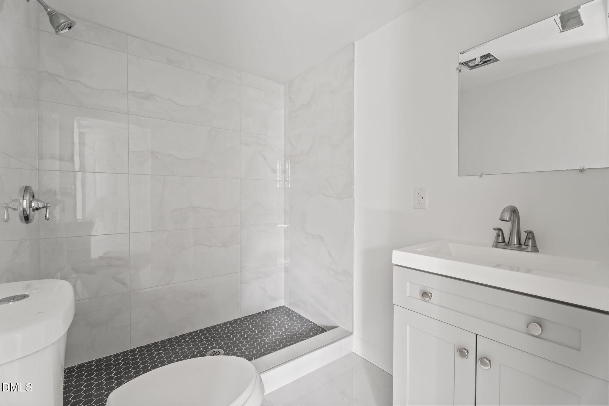 910 Gay Street Rocky Mount, NC 27804 - Photo 14 of 18 a bathroom with a toilet sink vanity and mirror