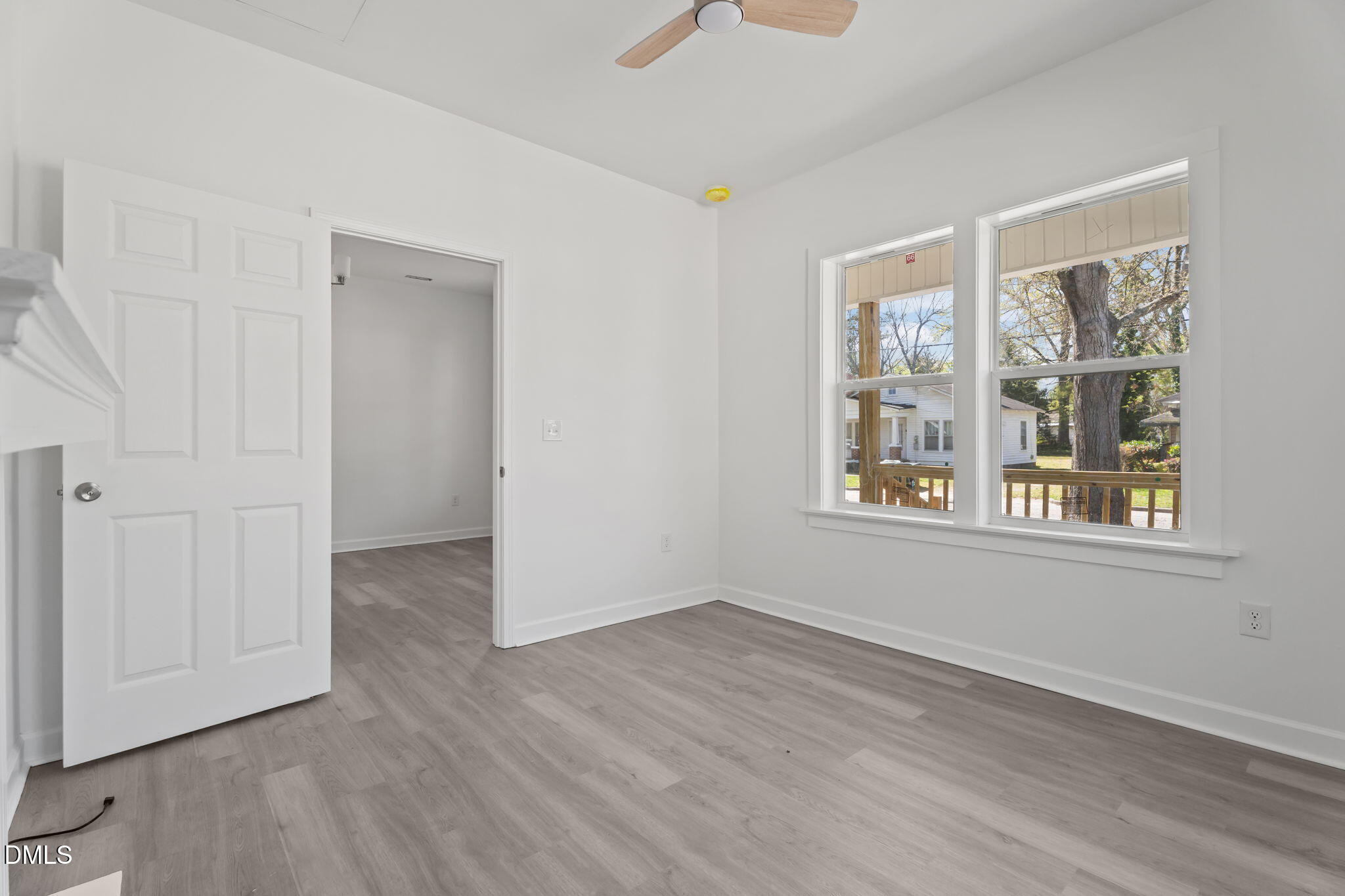 910 Gay Street Rocky Mount, NC 27804 - Photo 10 of 18 a view of an empty room with wooden floor and a window