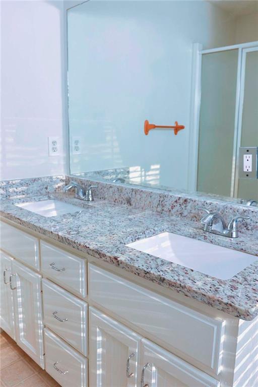 20 Hollow Court Covington, GA 30016 - Photo 13 of 29 a bathroom with a granite countertop sink and a mirror