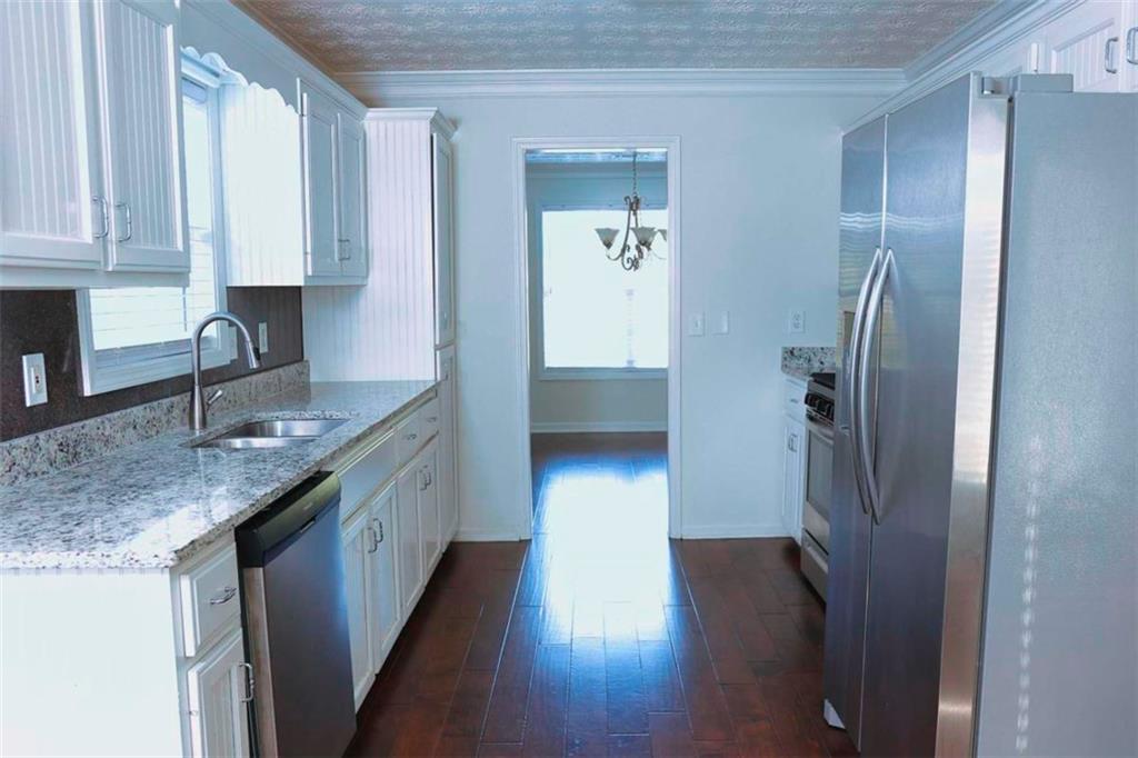 20 Hollow Court Covington, GA 30016 - Photo 7 of 29 a kitchen with stainless steel appliances granite countertop a refrigerator and a sink