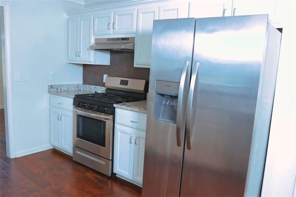 20 Hollow Court Covington, GA 30016 - Photo 8 of 29 a kitchen with stainless steel appliances wooden cabinets and a stove