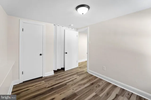 a view of a room with wooden floor