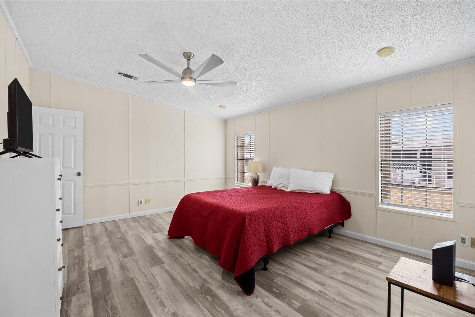 507 Tropical Isles Circle, Unit 25 Fort Pierce, FL 34982 - Photo 12 of 24 a bedroom with a bed and a flat tv screen on dresser