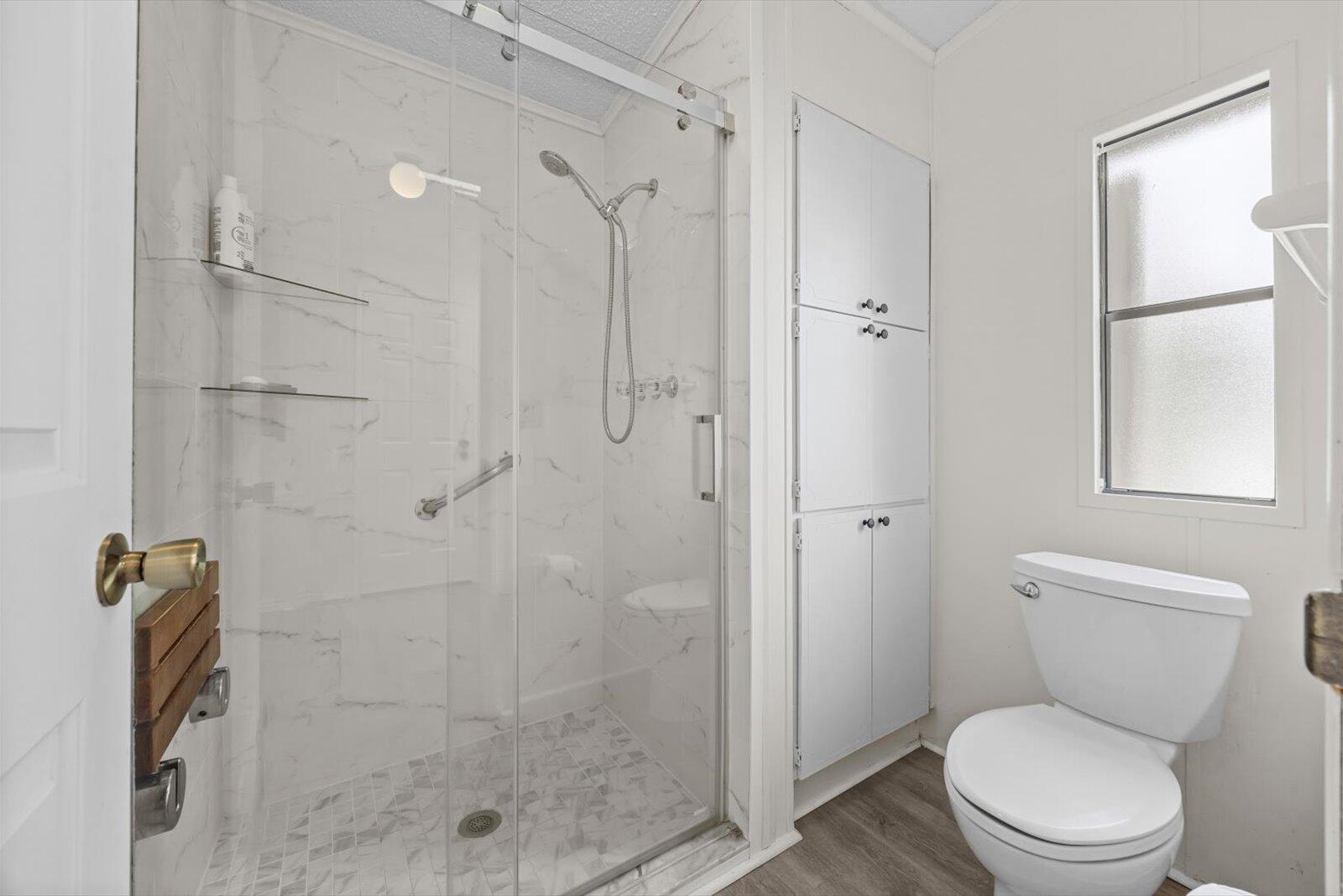 507 Tropical Isles Circle, Unit 25 Fort Pierce, FL 34982 - Photo 14 of 24 a bathroom with a toilet a shower and a sink