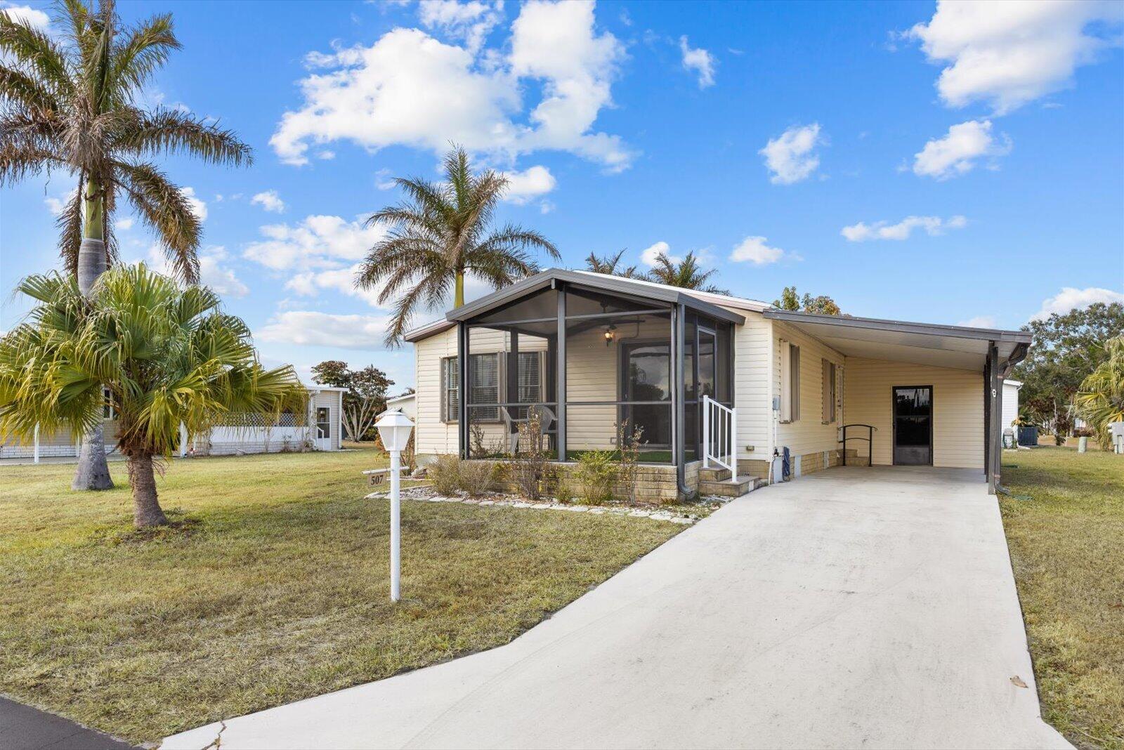 507 Tropical Isles Circle, Unit 25 Fort Pierce, FL 34982 - Photo 2 of 24 a view of a house with backyard and tree