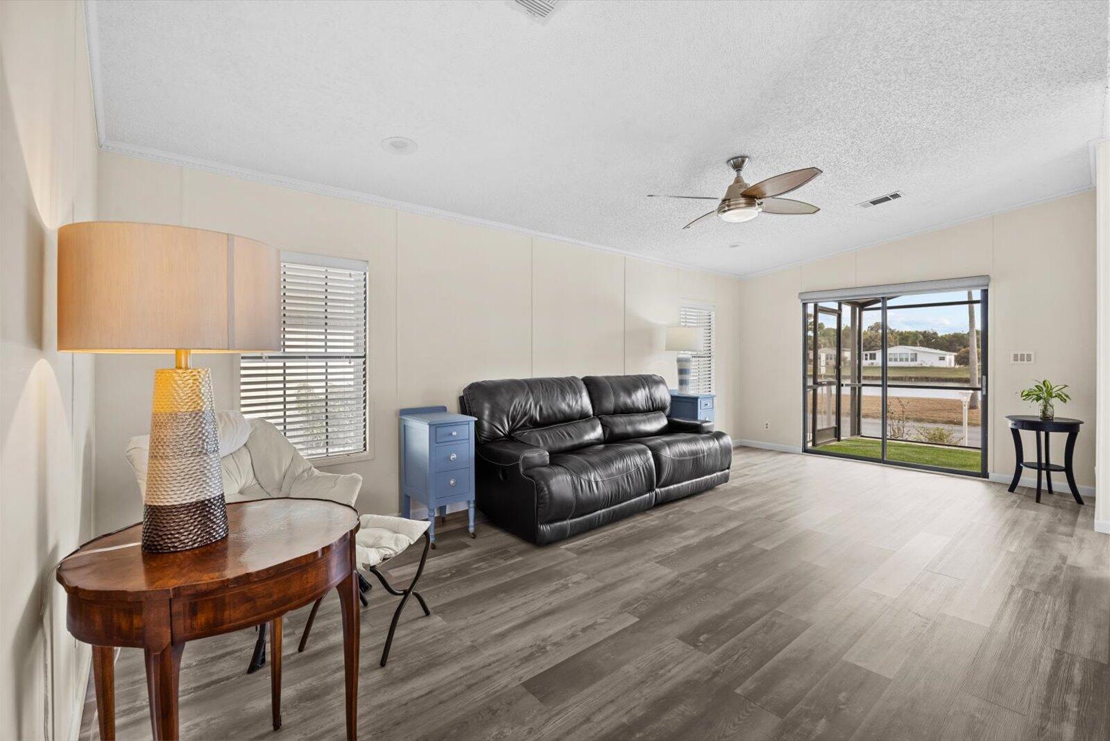 507 Tropical Isles Circle, Unit 25 Fort Pierce, FL 34982 - Photo 5 of 24 a living room with furniture and a large window