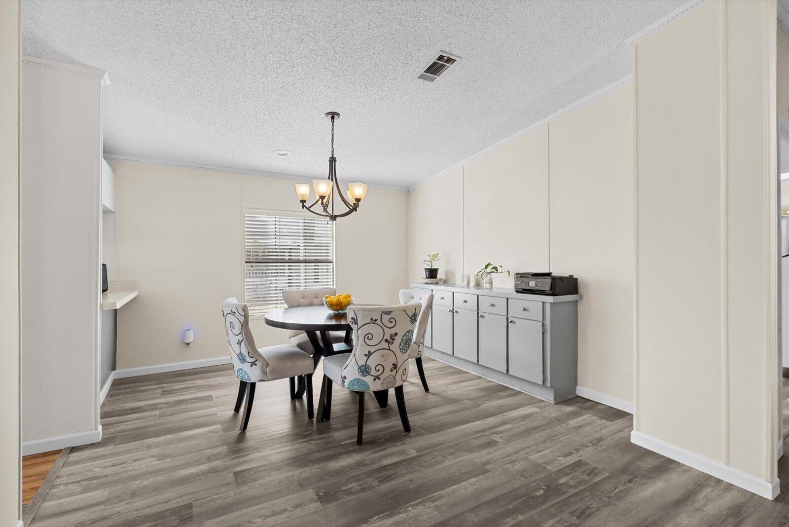 507 Tropical Isles Circle, Unit 25 Fort Pierce, FL 34982 - Photo 6 of 24 a view of a dining room with furniture and wooden floor