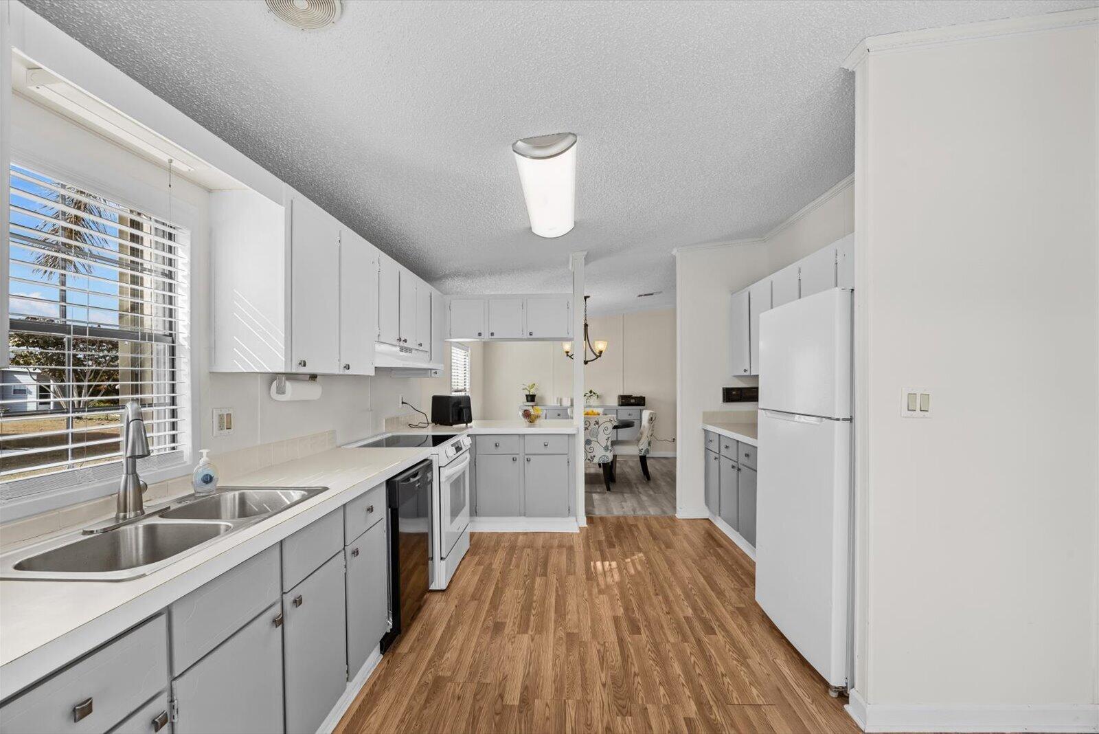 507 Tropical Isles Circle, Unit 25 Fort Pierce, FL 34982 - Photo 9 of 24 a kitchen with a sink a counter top space stainless steel appliances and cabinets