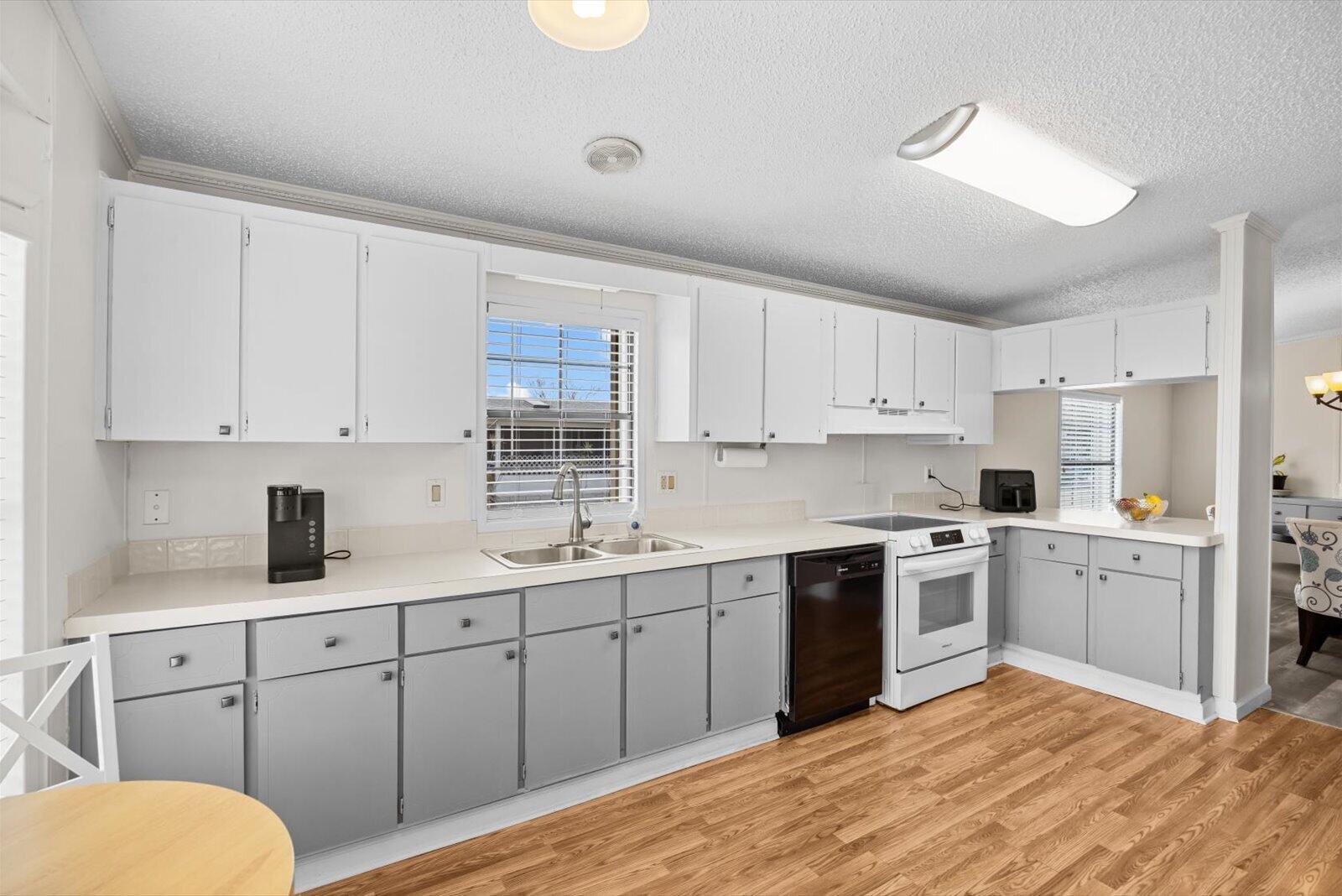 507 Tropical Isles Circle, Unit 25 Fort Pierce, FL 34982 - Photo 10 of 24 a kitchen with white cabinets appliances and sink