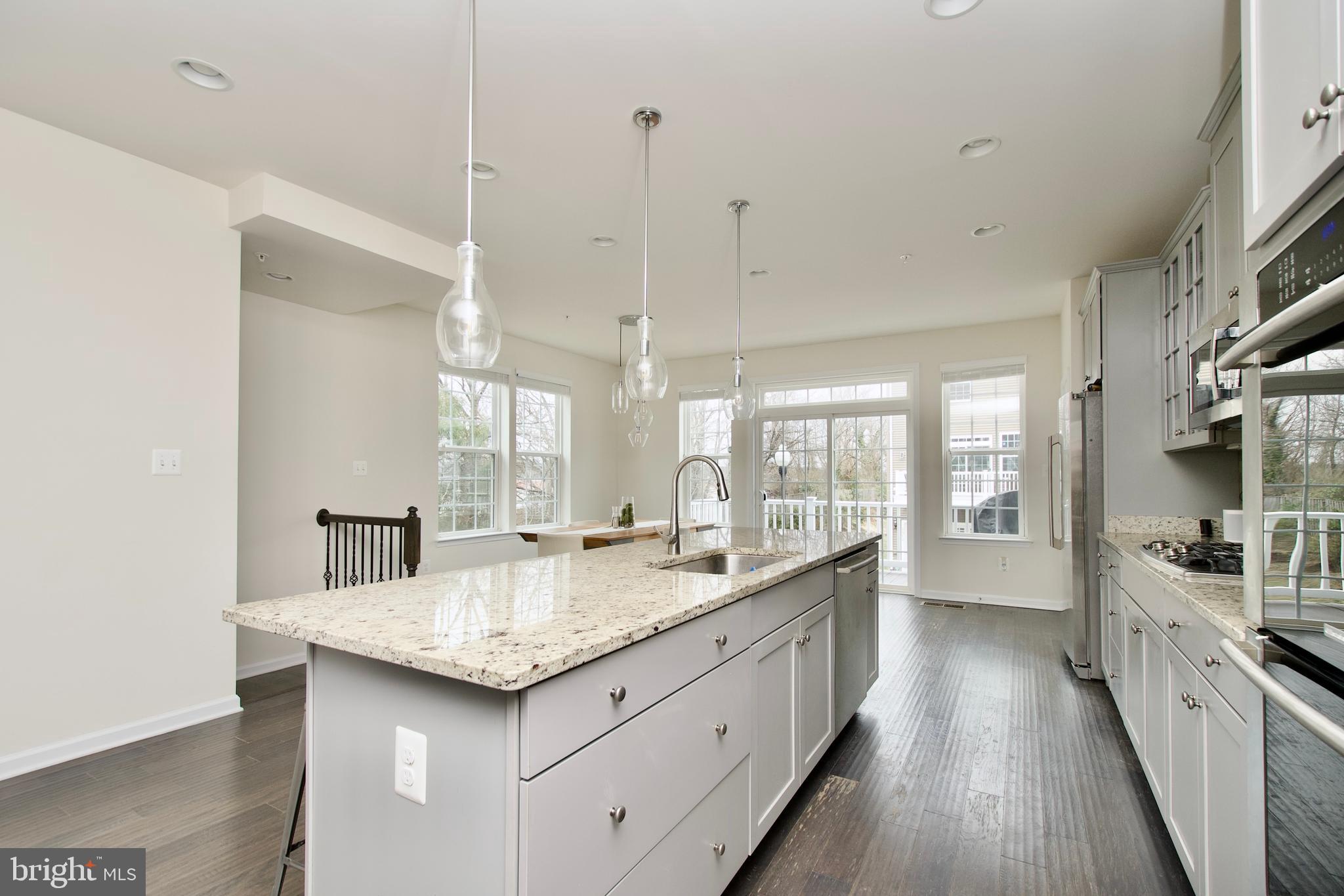 2900 Pinebrook Road Landover, MD 20785 - Photo 13 of 46 a kitchen with granite countertop kitchen island a sink appliances and a counter top space
