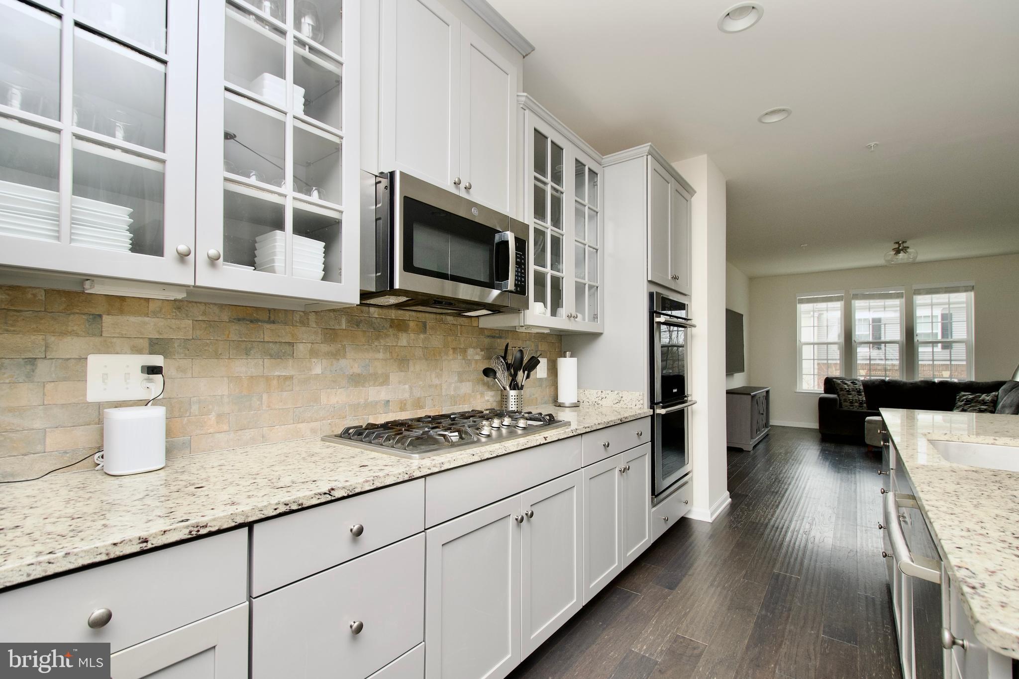 2900 Pinebrook Road Landover, MD 20785 - Photo 14 of 46 a kitchen with stainless steel appliances kitchen island granite countertop a sink and cabinets