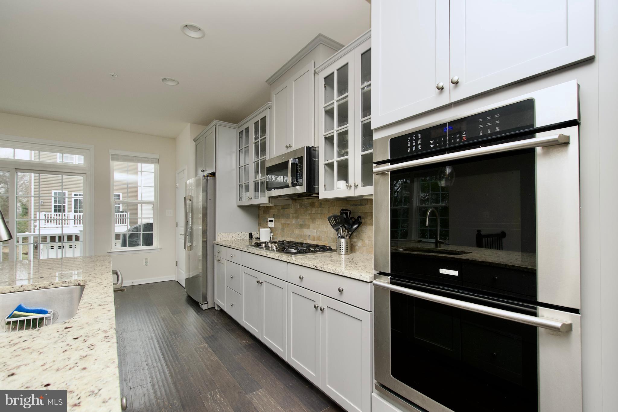 2900 Pinebrook Road Landover, MD 20785 - Photo 15 of 46 a kitchen with stainless steel appliances a stove sink and cabinets