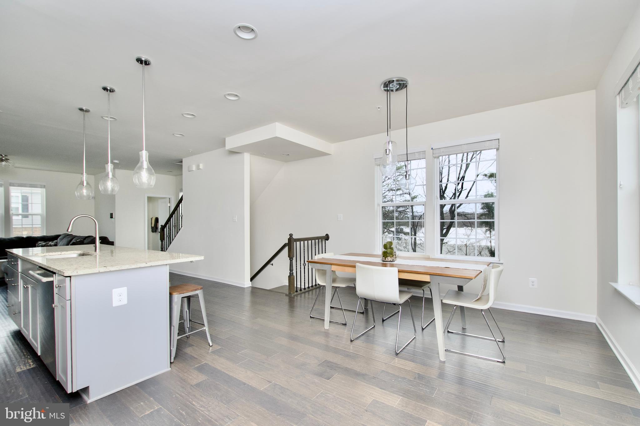 2900 Pinebrook Road Landover, MD 20785 - Photo 20 of 46 a room with a table chairs and a kitchen view